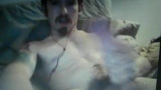 huge cock guy with tats shoots a heavy load of cum on cam