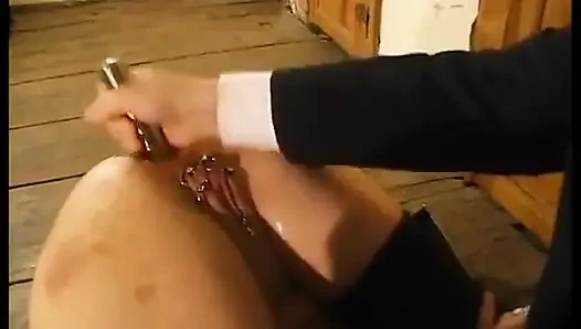 Tied up woman with clitoris piercings, sodomized by a stick