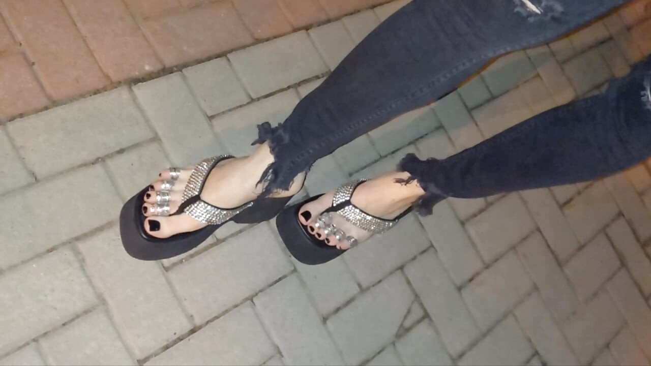 I wear platform flip-flops and tight jeans, showing off my feet.