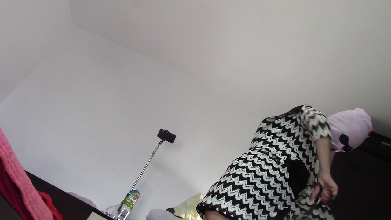 Amateur wife dancing naked at home. Amateur woman has fun trying on clothes and cutting them
