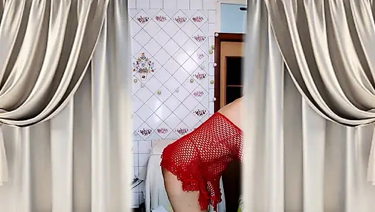 Hot housewife Lukerya in a red mesh dress flirts and makes coffee in the kitchen.