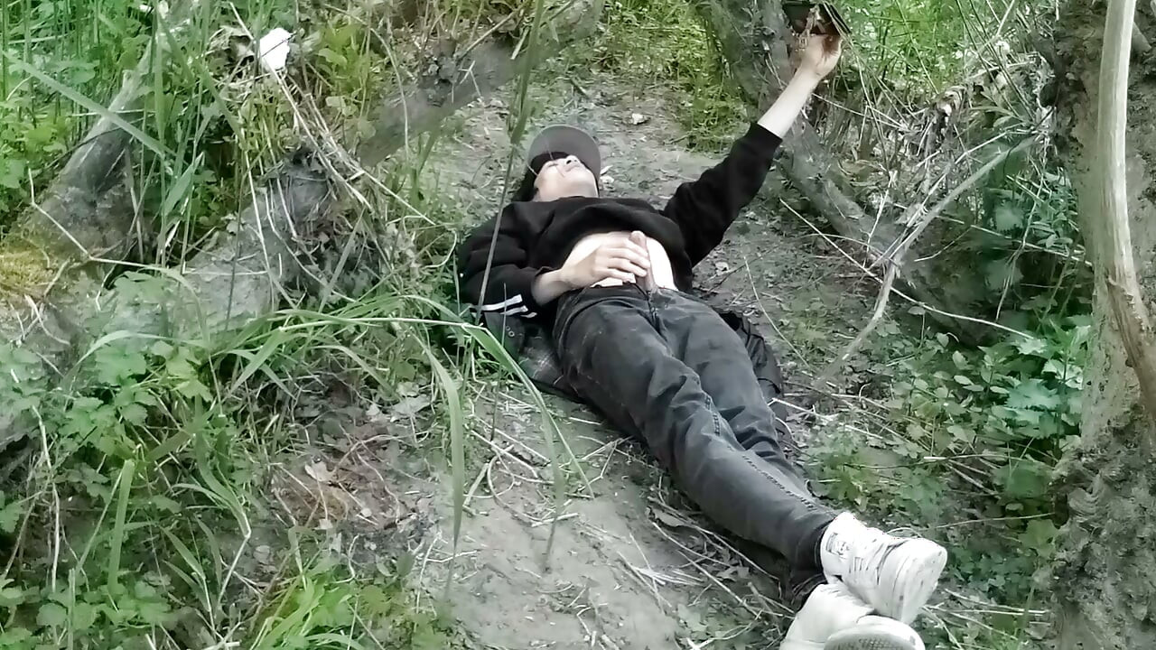 This gay twink sticks his cock through his fly to jerk off outside