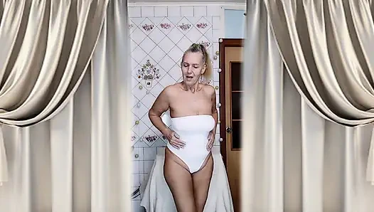 Housewife Lukerya warms up in the kitchen and flirts playfully on webcam.