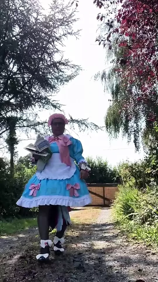In a blue maid outfit with pink bows for a day