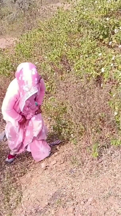 Sister-in-law is walking on the bridge by the roadside, getting down on the shore, sister-in-law started taking her… | Clip 1