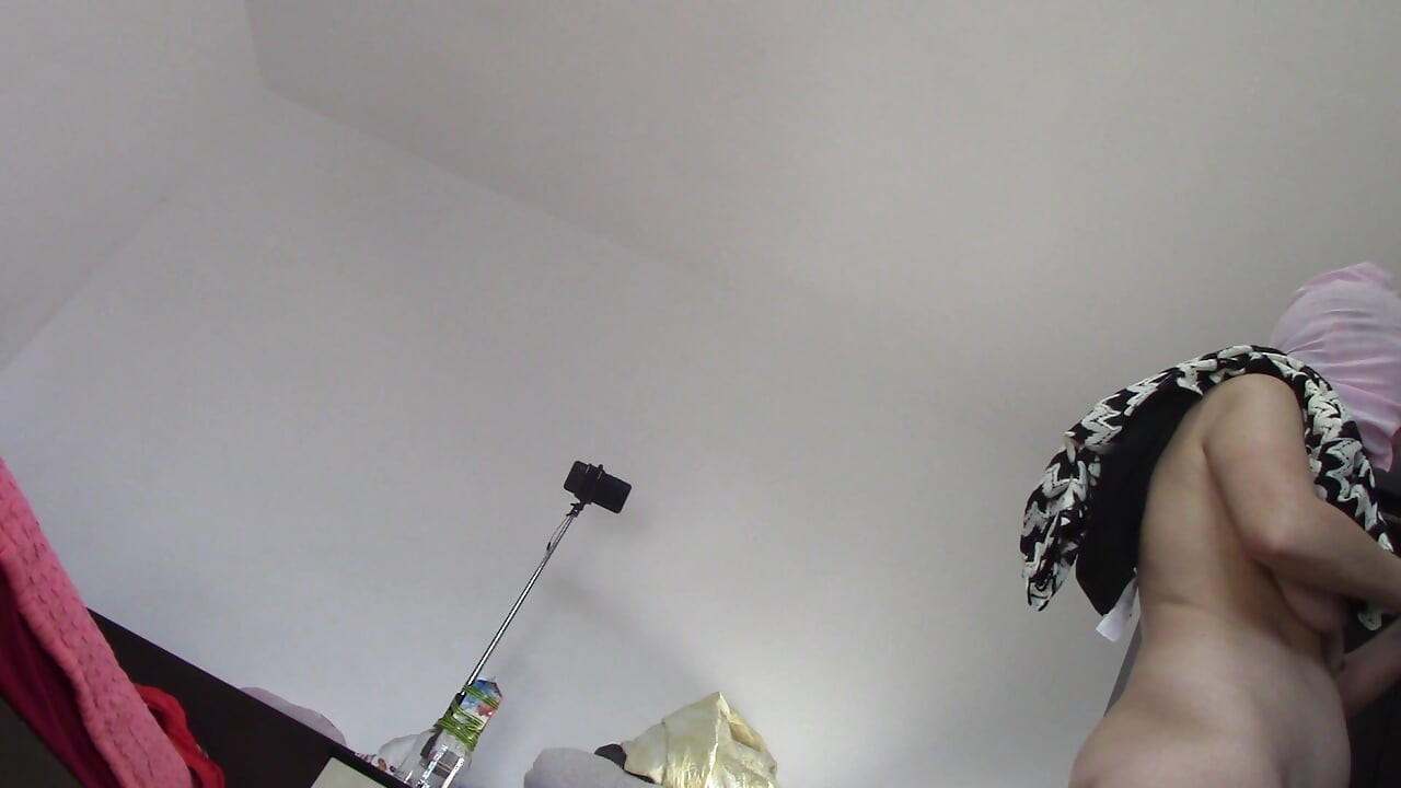 Amateur wife dancing naked at home. Amateur woman has fun trying on clothes and cutting them