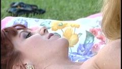 Outdoor lesbians lick and lap pussy on the lawn