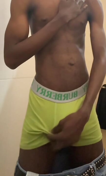 Sexy teen with abs stroking his big black cock in public