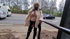 Exhibitionist whore flashing in a fur coat by a busy road
