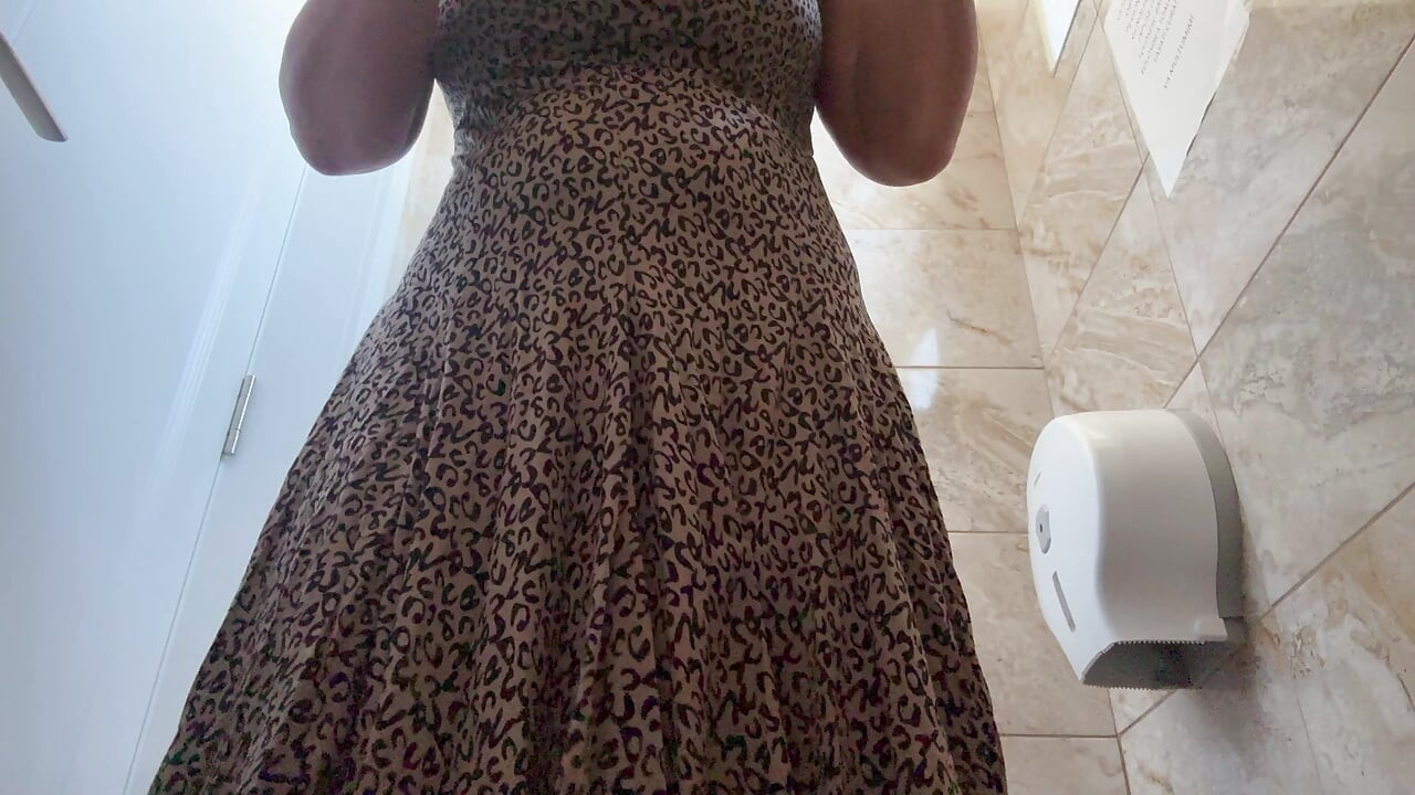 A horny mature MILF is very aroused and is rubbing her pussy in the public restroom at the office.