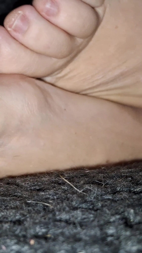 I candidly film her cute GILF feet while she restlessly rubs them together | Clip 1