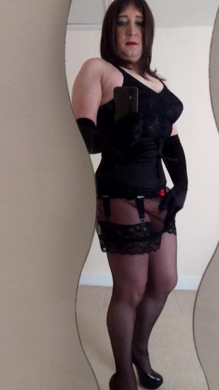 Transvestite in Corset and Stockings Stroking in the Mirror