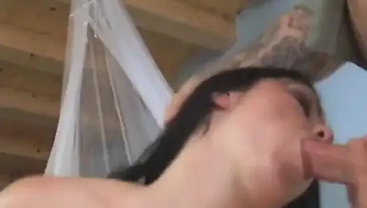 Dark haired skank in red fishnets rides a dick indoors