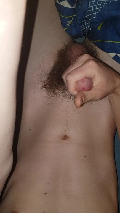 Teen masturbates and cums on his belly and navel