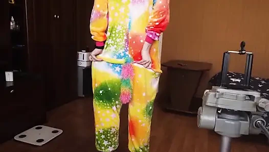 A baby in a unicorn costume shows off her ass