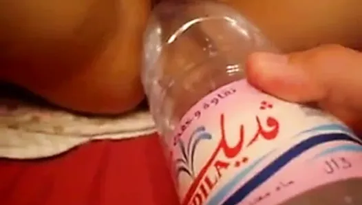 Arab girl fucks a bottle