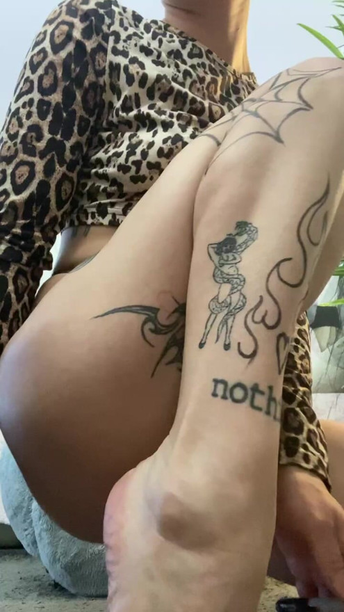 in panties and with bare legs covered in tattoos. admire this young naughty teen
