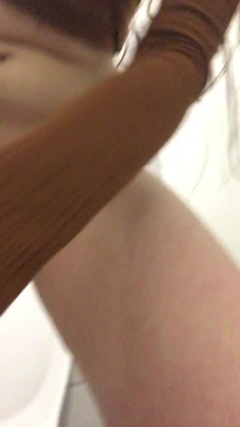 Key moment from "Slim pissing close-up in a public toilet. Russian pissing porn. Pissing standing hairy cunt"