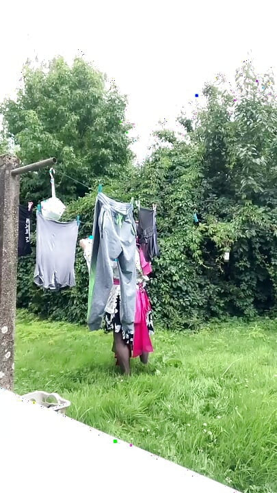 In gardening outfit to hang the laundry