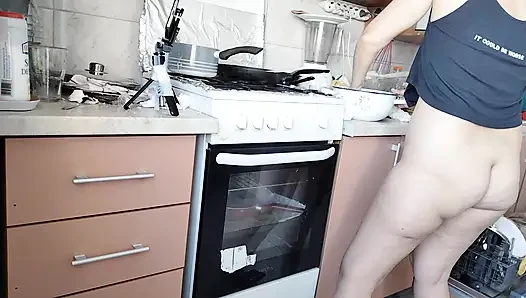 Sexy wife prepares lunch naked in the kitchen.