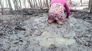 in a mini dress she is playing in the mud