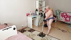 Mother-in-law vacuums the room naked