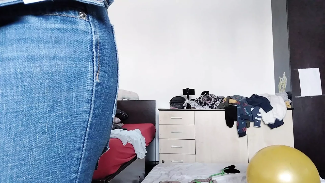 An amateur has fun trying on clothes she has cut. An amateur dances naked in the house.