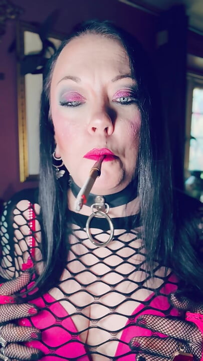 Pink & Delicious Tina Snua Sparks Up A Cigarette In A Holder