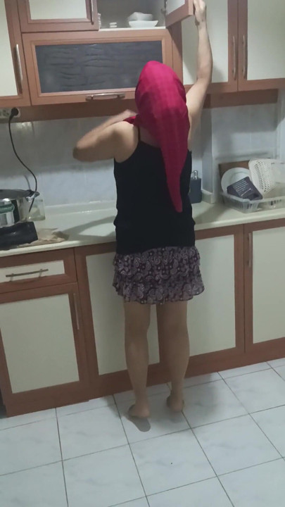 Mature woman in sheer stockings doing housework in the kitchen. | Clip 1