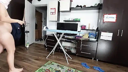 Sexy brunette doing naked chores around the house.