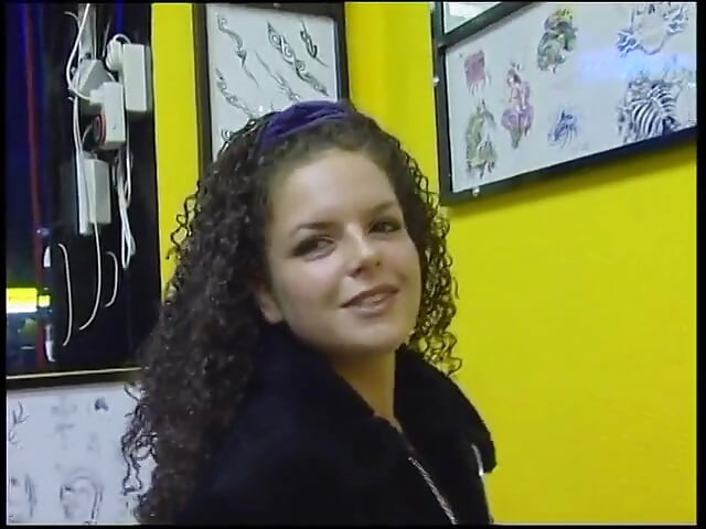 Fabulous brunette with curly hair wants a new tattoo