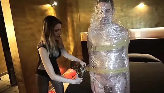 Femdom girl puts her slave in tape bondage