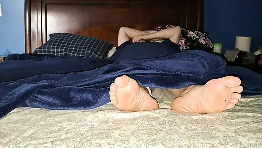 Relaxing in bed playing footsie with our bare feet after I fucked her pussy