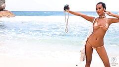 Putri Cinta stripping on a beautiful tropical beach
