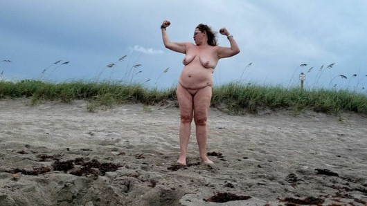 Mature BBW being silly and walking on nude beach.