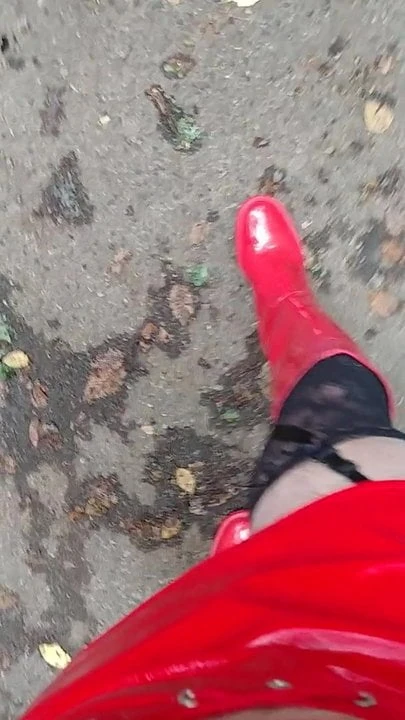 in red boots on a parking lot