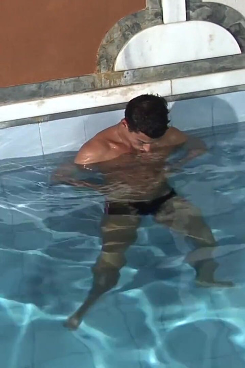 Latino dude jerking his dick nex to swimming pool