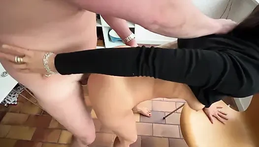 Wife interrupts husband as he does some electricity work in the kitchen