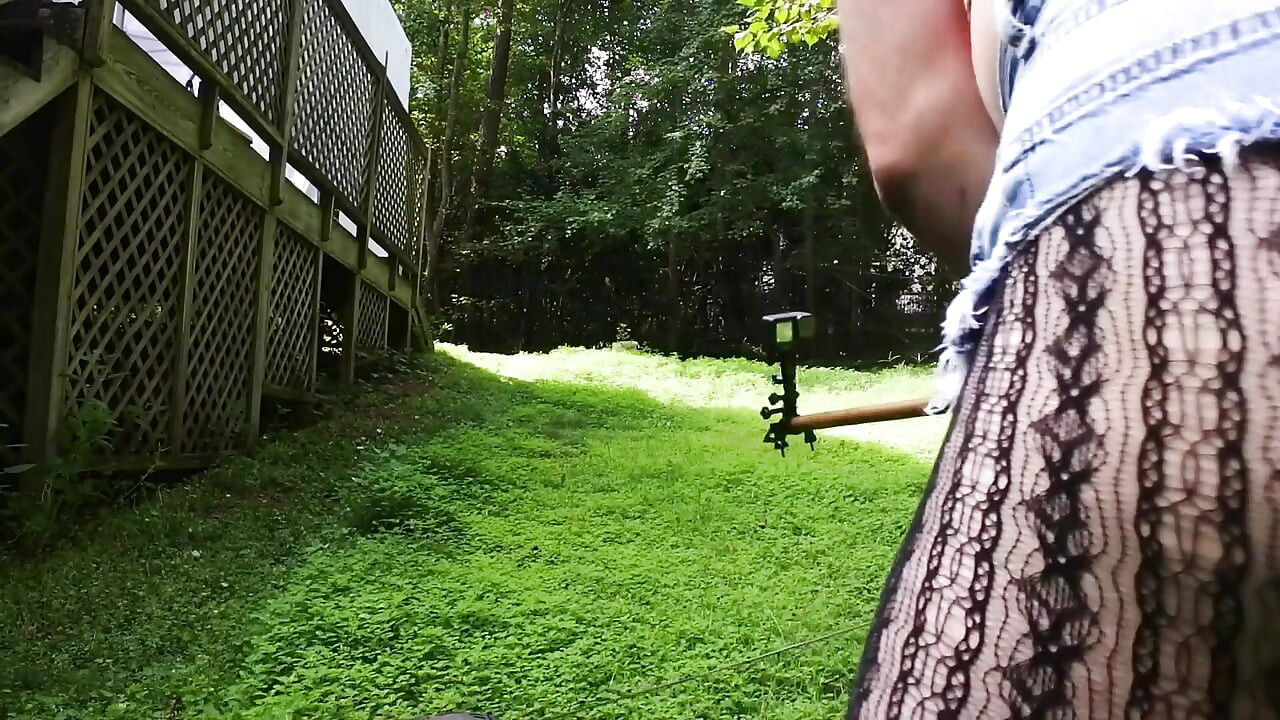 Big Fake Tits Crossdresser in Daisy Dukes Mowing Grass