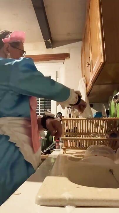 In a blue maid's outfit with pink bows to do the dishes.