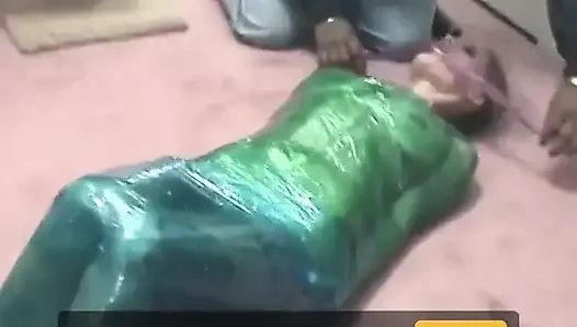 Fetish chick loves being wrapped in green plastic with her shaved pussy