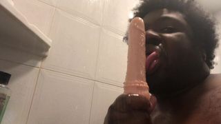Sucking a didlo sex toy in the shower