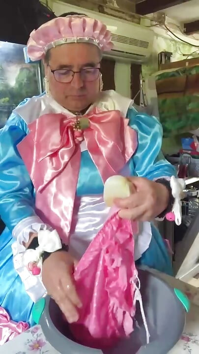 In a blue maid's outfit with pink bows to do the laundry.