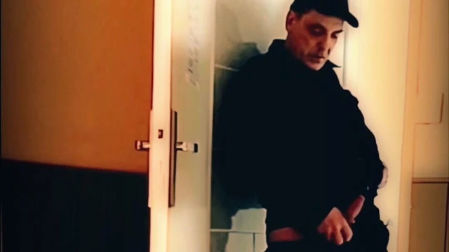 Handjob standing in front of a door