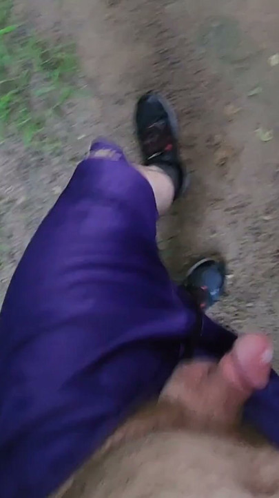 Walking outside under a railroad bridge enjoying the park. | Clip 1