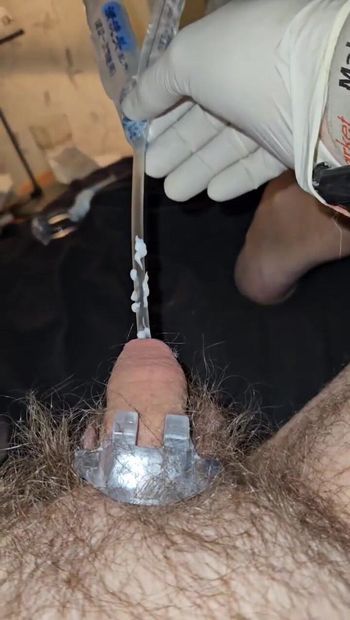Een katheter in de penis steken tijdens het dragen van operatiehandschoenen