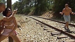 Stunning French babe gets fucked by two dudes on the railway