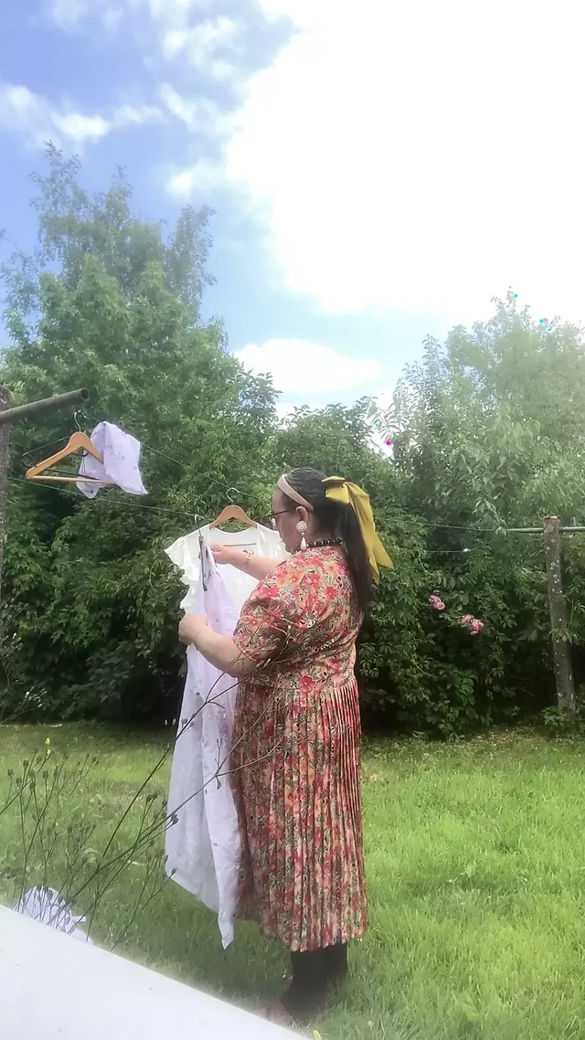 In vintage floral pattern dress for a day hanging laundry