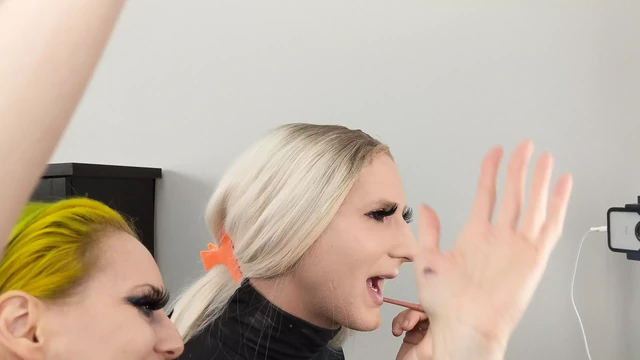 Crossdresser and Woman Putting on Lipliner and Lipstick