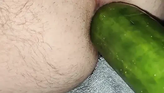 My wife is fucking my ass with a huge cucumber.